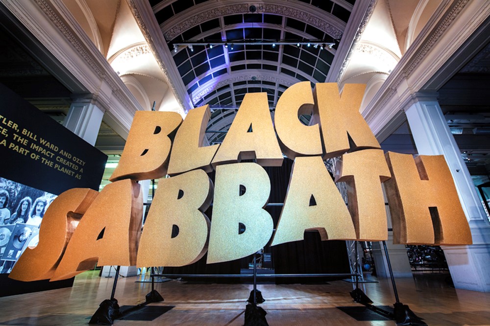 Image of large 3D text sculpture, showing gold text reading 'Black Sabbath' as part of Home of Metal exhibition at Birmingham Museums