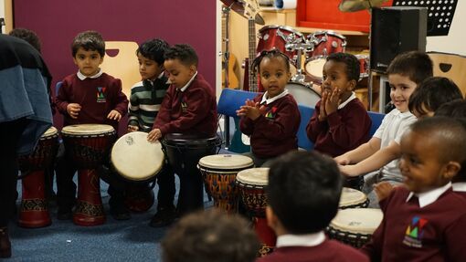 Children in a music room playing instruments.
