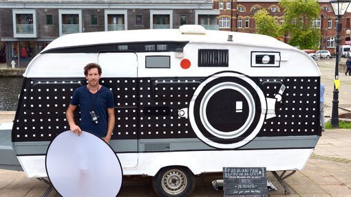 Photographer Brendan Barry stands in front of his converted caravan. The Caravan Cam is a portable camera obscura. 