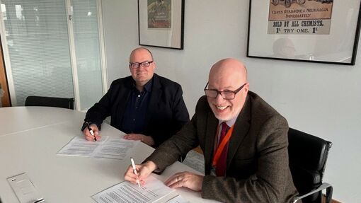 Darren Henley and Jeff James signing the agreement.